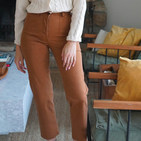 Model wears a straight leg work pant in the shade Tan. The James Pant in Tan is designed by Loup and made in New York City, USA.