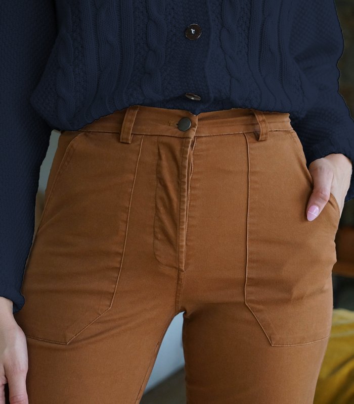 A close up shot of the button down fly and front pockets of straight leg work pant in the shade Tan. The James Pant in Tan is designed by Loup and made in New York City, USA.