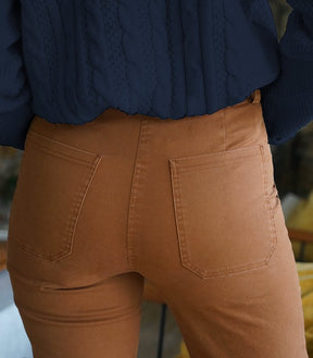 A close up shot of the back side of a model wearing a straight leg work pant in the shade Tan. The James Pant in Tan is designed by Loup and made in New York City, USA.