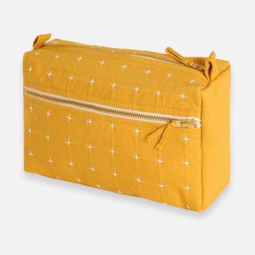 Square  toiletry bag in the shade Mustard with white cross-stitch detailing. Designed by Anchal in Louisville, Kentucky and Handmade in Ajmer, India.