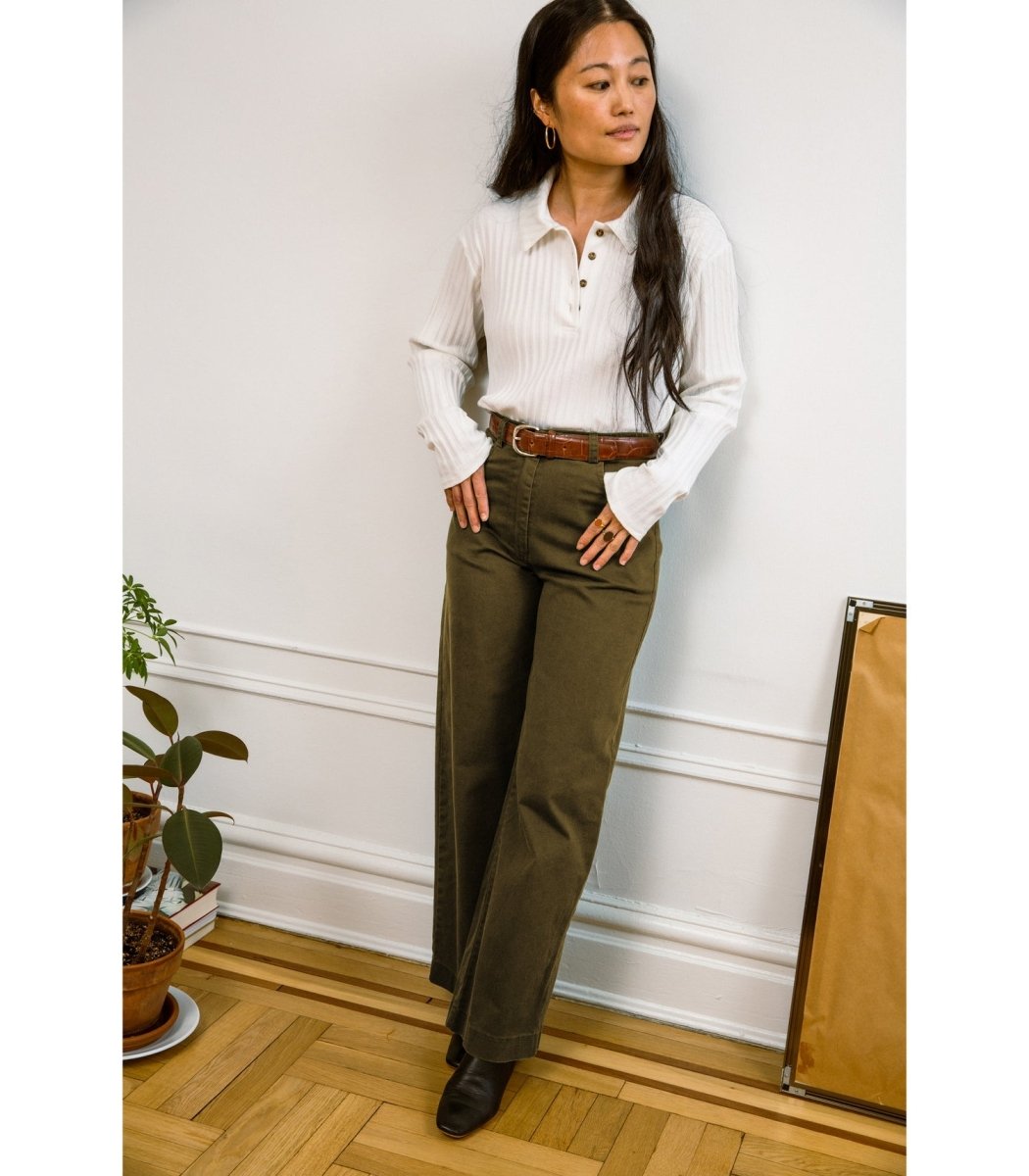 Model wears a high waisted wide leg jean in a dark green color. The Toni Jean in Moss is designed by Loup and made in New York City, USA.