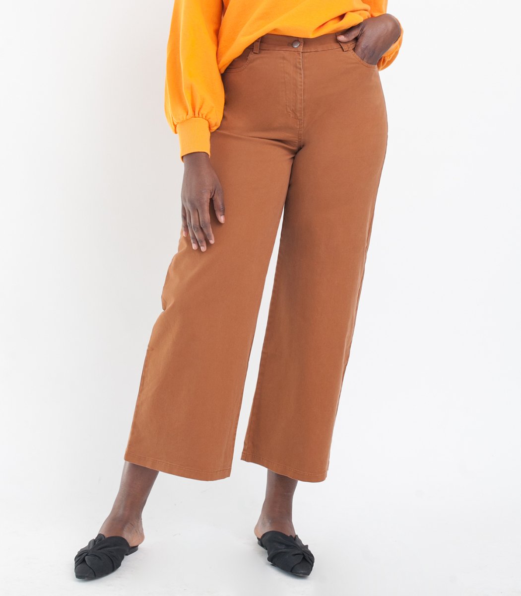 Model wears cropped wide leg jeans in Tan. The Toni Jeans in Tan are designed by Loup and made in New York City, USA.