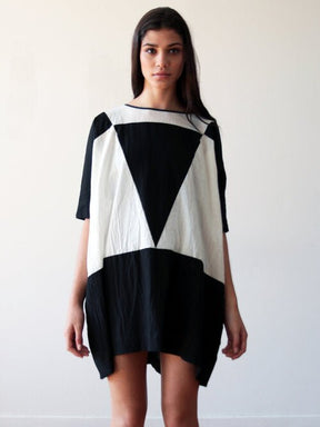 Black and cream tunic style dress with a color-blocked triangle design. Designed and sewn by UZI in Brooklyn, New York.