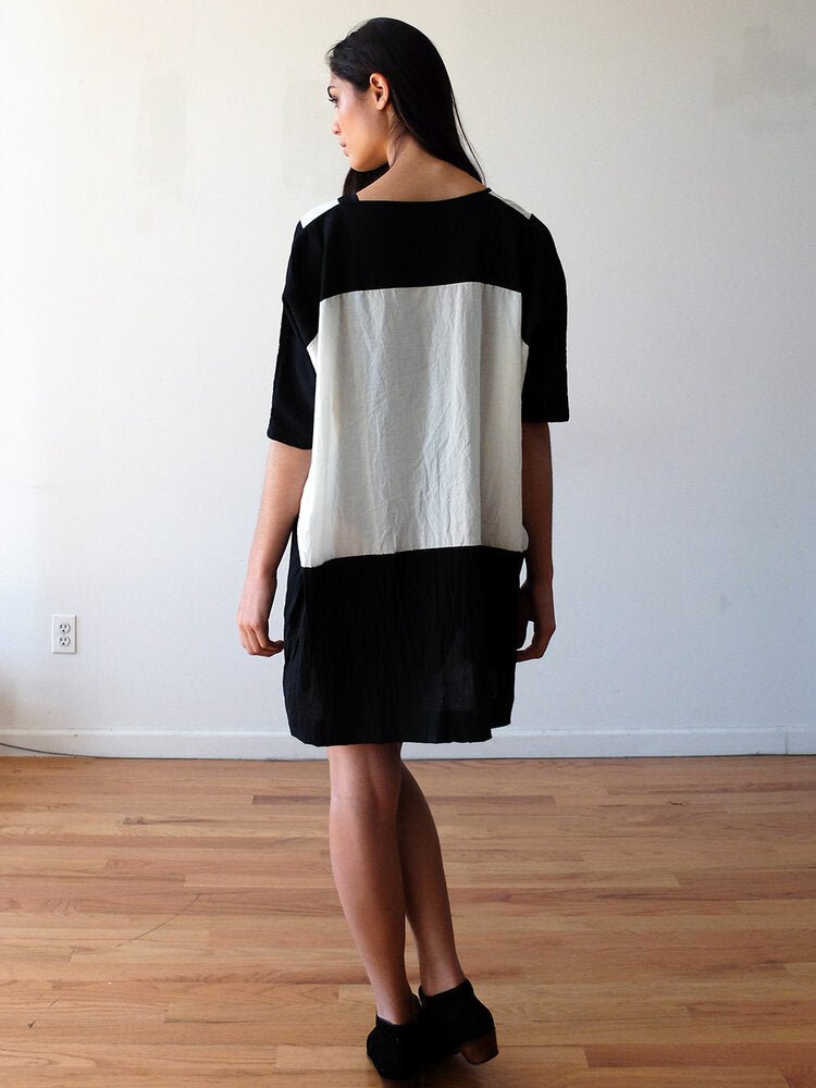 Back of black and cream tunic style dress with a color-blocked geometric design. Designed and sewn by UZI in Brooklyn, New York.