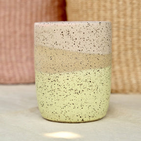 10oz tumbler glazed with matte yellow and pink colors over a speckled clay body. Designed and handmade by Sunflower Studio in Portland, Oregon.
