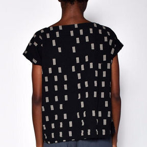 Black short sleeve tunic with faded white square pattern. Designed and sewn by UZI in Brooklyn, New York.