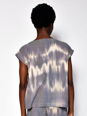 Model shows back side of short sleeve tunic with violet and white rippled tie dye effect. Designed and sewn by UZI in Brooklyn, New York.