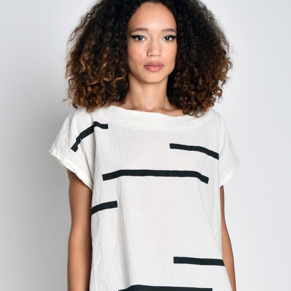 White short sleeved tunic with black horizontal stripes. Designed and sewn by UZI in Brooklyn, New York.