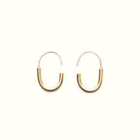 A mini brass hoop U-shaped earring with an arched sterling silver ear wire with a slight opening. Designed and handcrafted in Portland, Oregon.