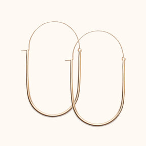  A large gold-fill U-shaped earring with an arched ear wire that meets the top of the U. Designed and handcrafted in Portland, Oregon.