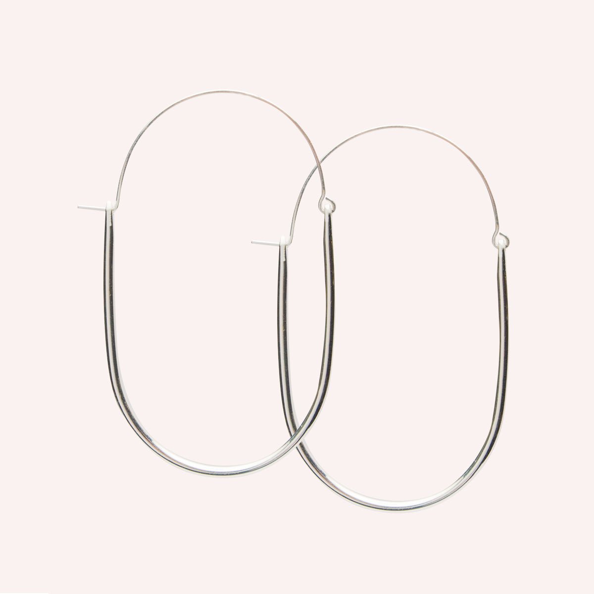 A large sterling silver U-shaped earring with an arched ear wire that meets the top of the U. Designed and handcrafted in Portland, Oregon.