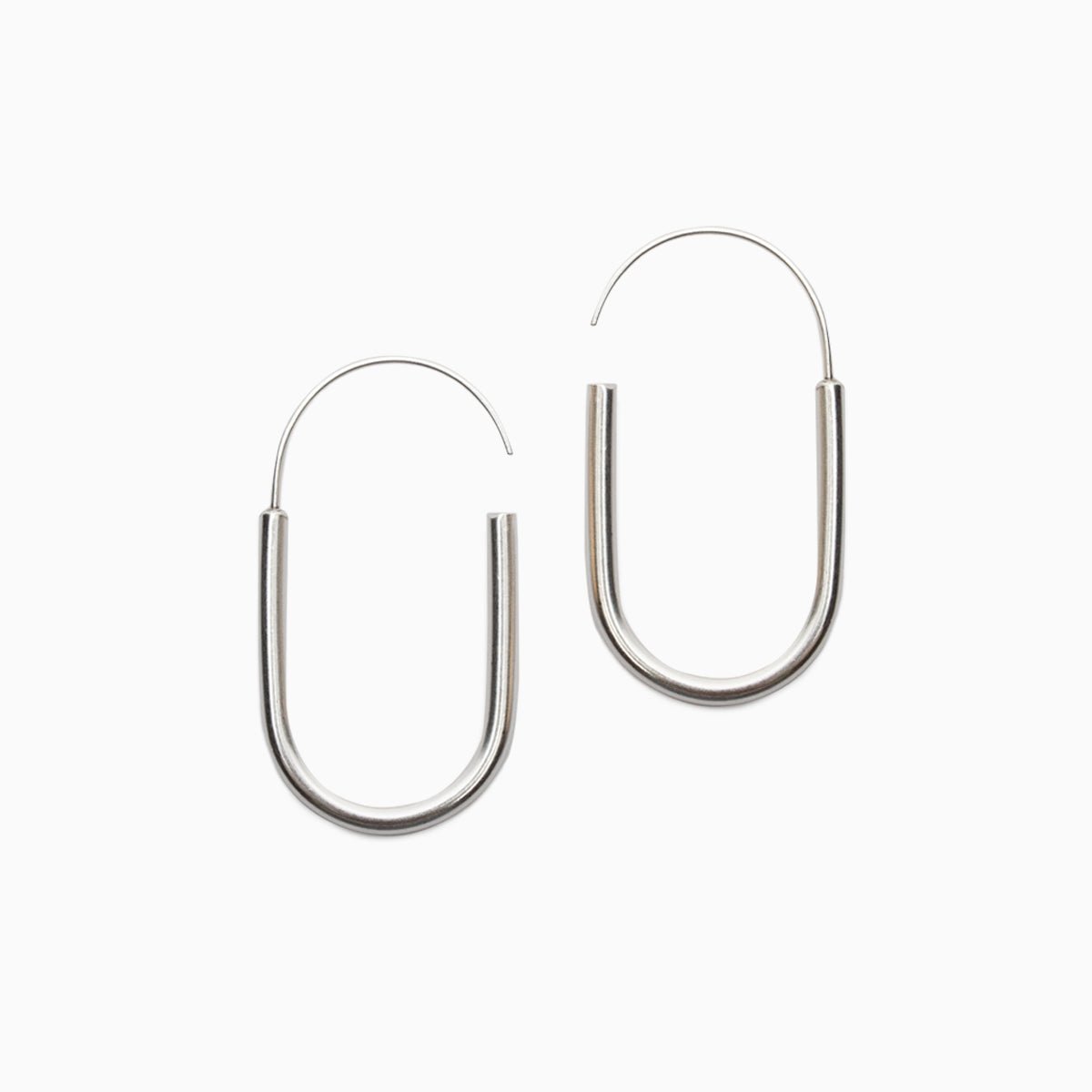 A small sterling silver U-shaped earring with an arched sterling silver ear wire that leaves a slight opening. Designed and handcrafted in Portland, Oregon.