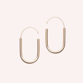 A small gold-fill U-shaped earring with an arched gold-fill ear wire that leaves a slight opening. Designed and handcrafted in Portland, Oregon.