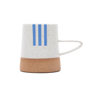 Handle mug with a white speckled and natural clay finish along with blue detailing. The Tucker Mug with Red Detail is designed and handmade by Wolf Ceramics in Hood River, Oregon.