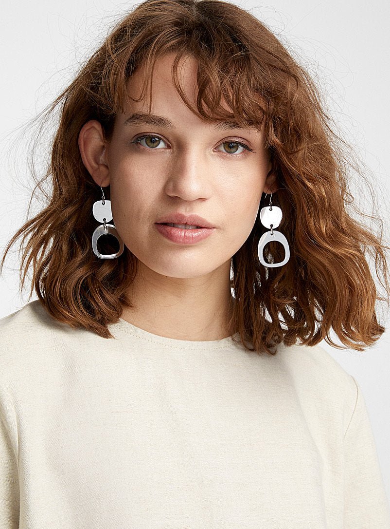 Model wears Inverted Ovoid Mini Earrings in Silver. Made in Canada by Warren Steven Scott.
