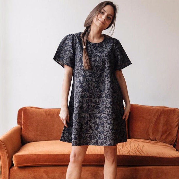 Mini dress with lightly ruffled shoulders in a navy jungle print. Designed by Mata Traders and made in India.