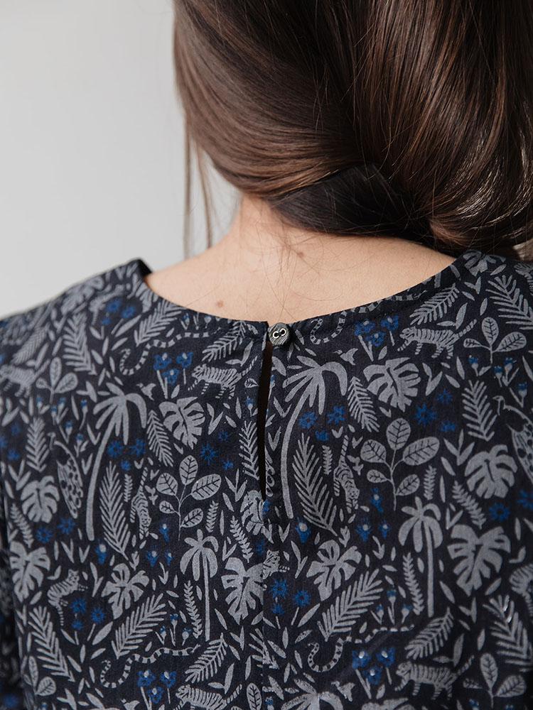 Model shows back detail of the Winnie Dress in Midnight Jungle. Designed by Mata Traders and made in India.