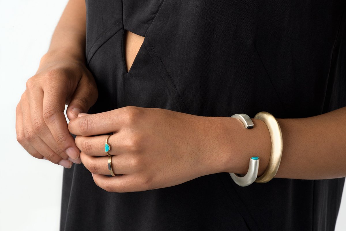 Sterling Silver and Bronze Cima cuffs on model's wrist