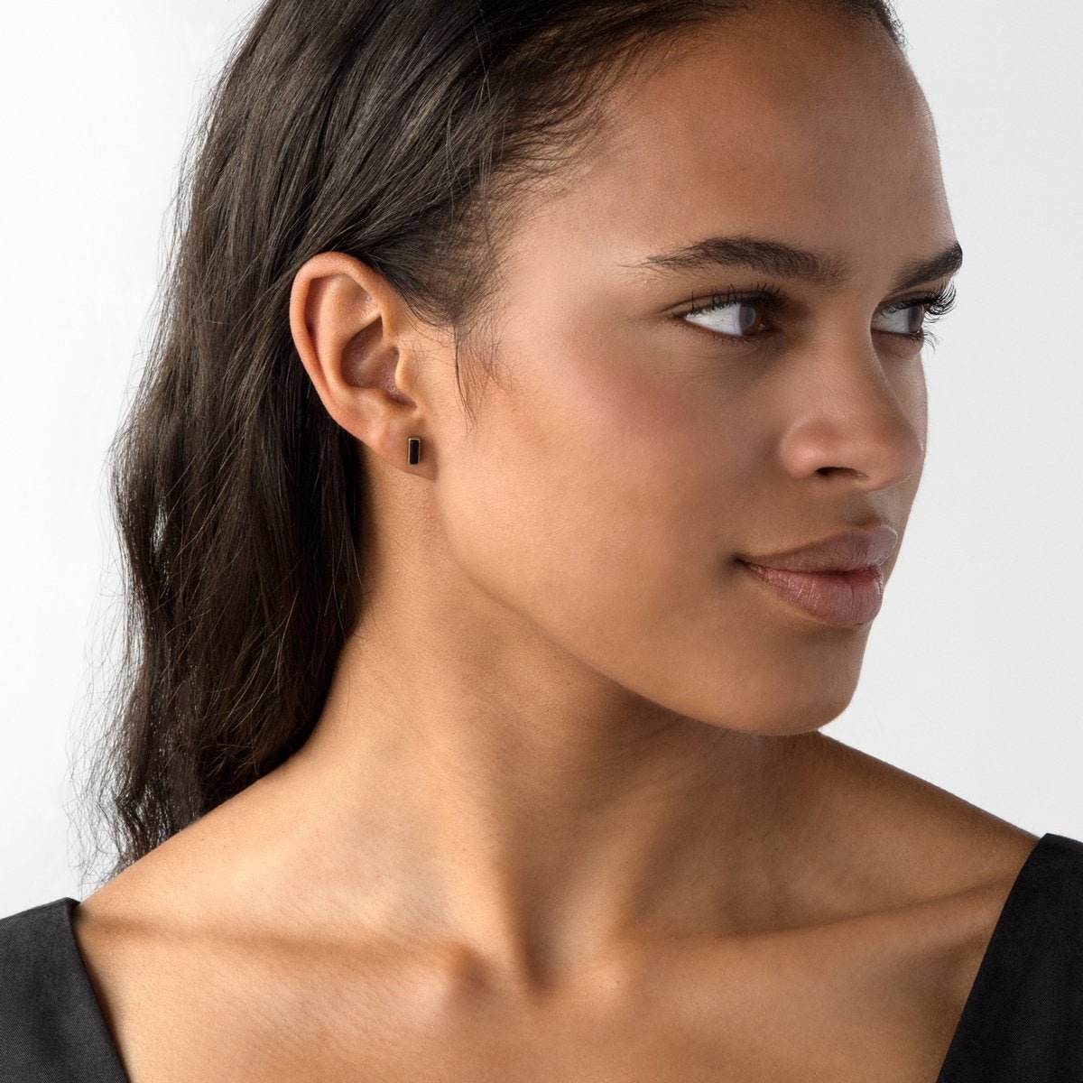 Bronze Yana mini-rectangle stud earrings with black jasper on model