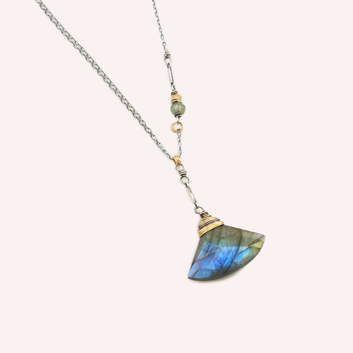 The Luna Necklace features a green garnet bead and brass nugget on the sterling chain. Made in Portland, Oregon by designer Amy Olson.