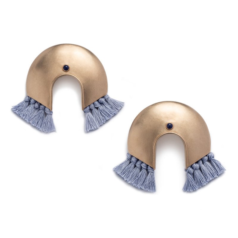 Oversized, arc-shaped bronze earrings with light blue cotton fringe and ethically sourced, fair trade lapis lazuli. Hand-crafted in Portland, Oregon. 