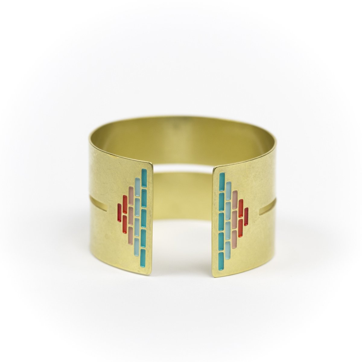 Wide, bold, brass cuff bracelet in the Mexico colorway, with a cutout slit that runs through the center of the cuff and stops just short of a pyramid of rich teal and red paint on either end. Hand-crafted in Portland, Oregon. 