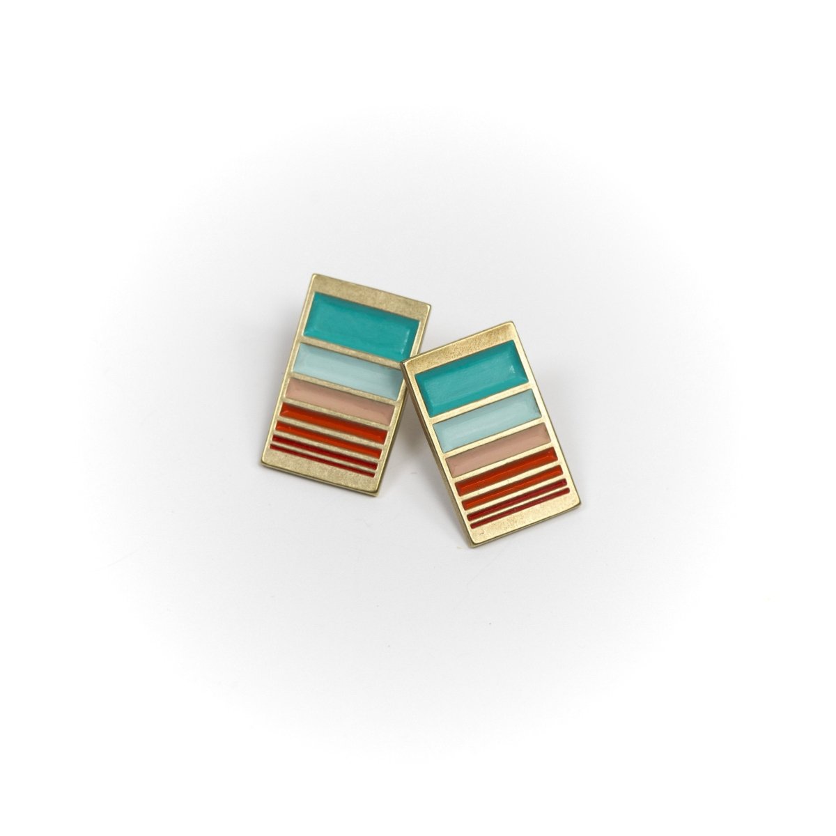 A pair of rectangular, cast-bronze stud earrings, decorated in our Mexico colorway, with a gradient of rich teal and red paint. Hand-crafted in Portland, Oregon. 