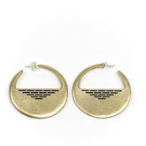 A pair of cast-bronze disc hoop earrings, decorated with a pyramid of geometric, black paint detail through the center of the disc, and finished with sterling silver posts and butterfly backings. Hand-crafted in Portland, Oregon. 