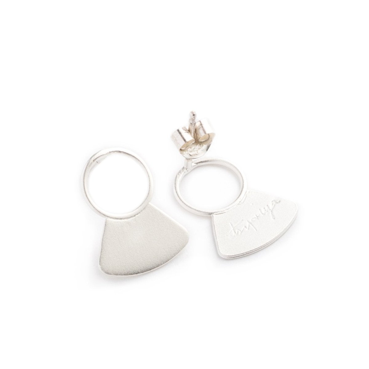 Small, sterling silver studs, featuring a delicate, open circle with a solid fan shape at the base, sterling silver earring posts and backings, and the betsy & iya logo etched on the back of the studs. Hand-crafted in Portland, Oregon.