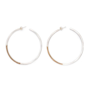 Classic, large, lightweight hoop earrings of mixed brass and sterling silver hand-forged wire, with sterling silver earring posts and sterling silver butterfly backings. Hand-crafted in Portland, Oregon.