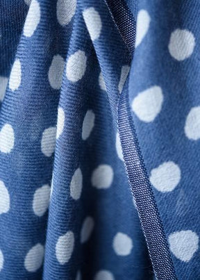 Closeup of the fabric in the Maya Dot Scarf in Blue from Bloom & Give. The scarf is 92% Merino Wool and 8% Silk.