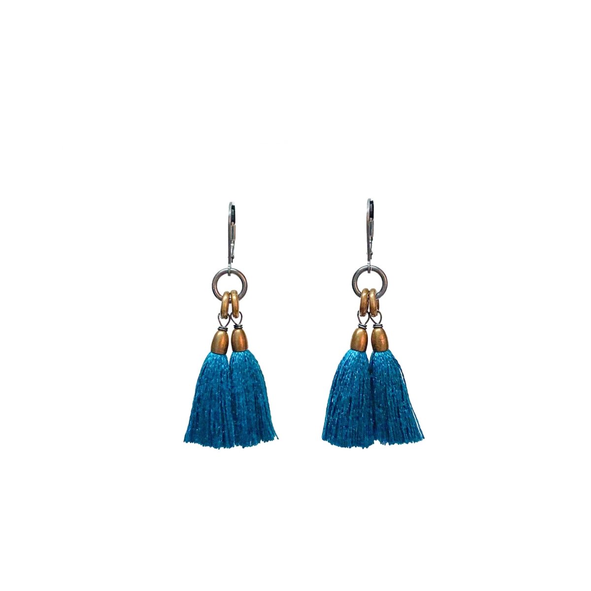 A pair of dangling earrings with teal tassels and brass rings topped with a silver leverback. The Fan Earrings in Peacock are from Portland designer Emily Bixler of BOET.