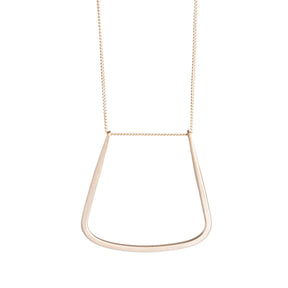 14k gold-filled chain threaded through a hand-formed, 14k gold-filled, u-shaped pendant with squared edges. Hand-crafted in Portland, Oregon. 