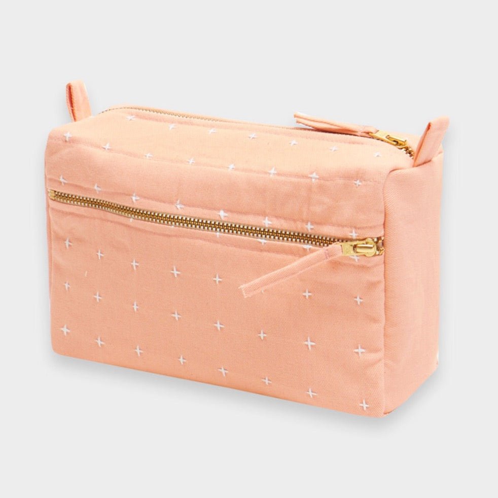 Square cross-stitch toiletry bag with side and top zipper in the shade Pink. Designed by Anchor in Louisville, Kentucky and handmade in Ajmer, India.