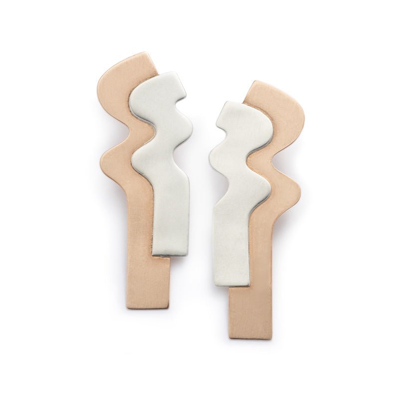 Sleek stud earrings with long curves of flat, layered bronze and silver. Hand-crafted in Portland, Oregon.