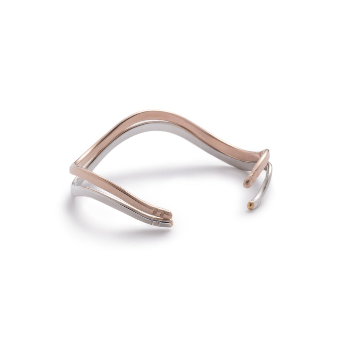 A stacking pair of bronze and sterling silver betsy & iya Fluit cuff bracelets. Hand-crafted in Portland, Oregon.