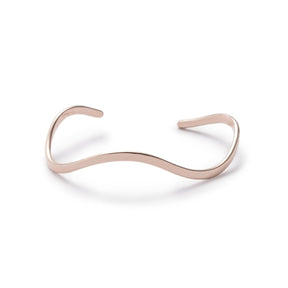 Thin, shiny, bronze cuff bracelet, with a curved, organic shape, and notch details at each end. Hand-crafted in Portland, Oregon.