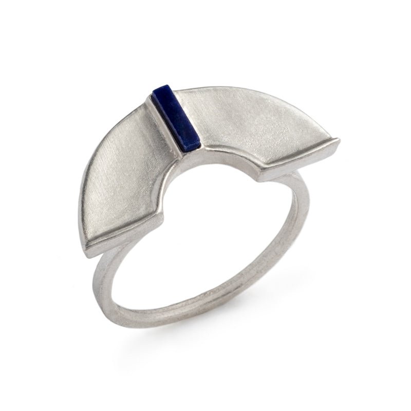 A unique, sterling silver, half-circle shield, set atop a sterling silver band, and inlaid with a rectangular, blue, lapis lazuli stone. Hand-crafted in Portland, Oregon.