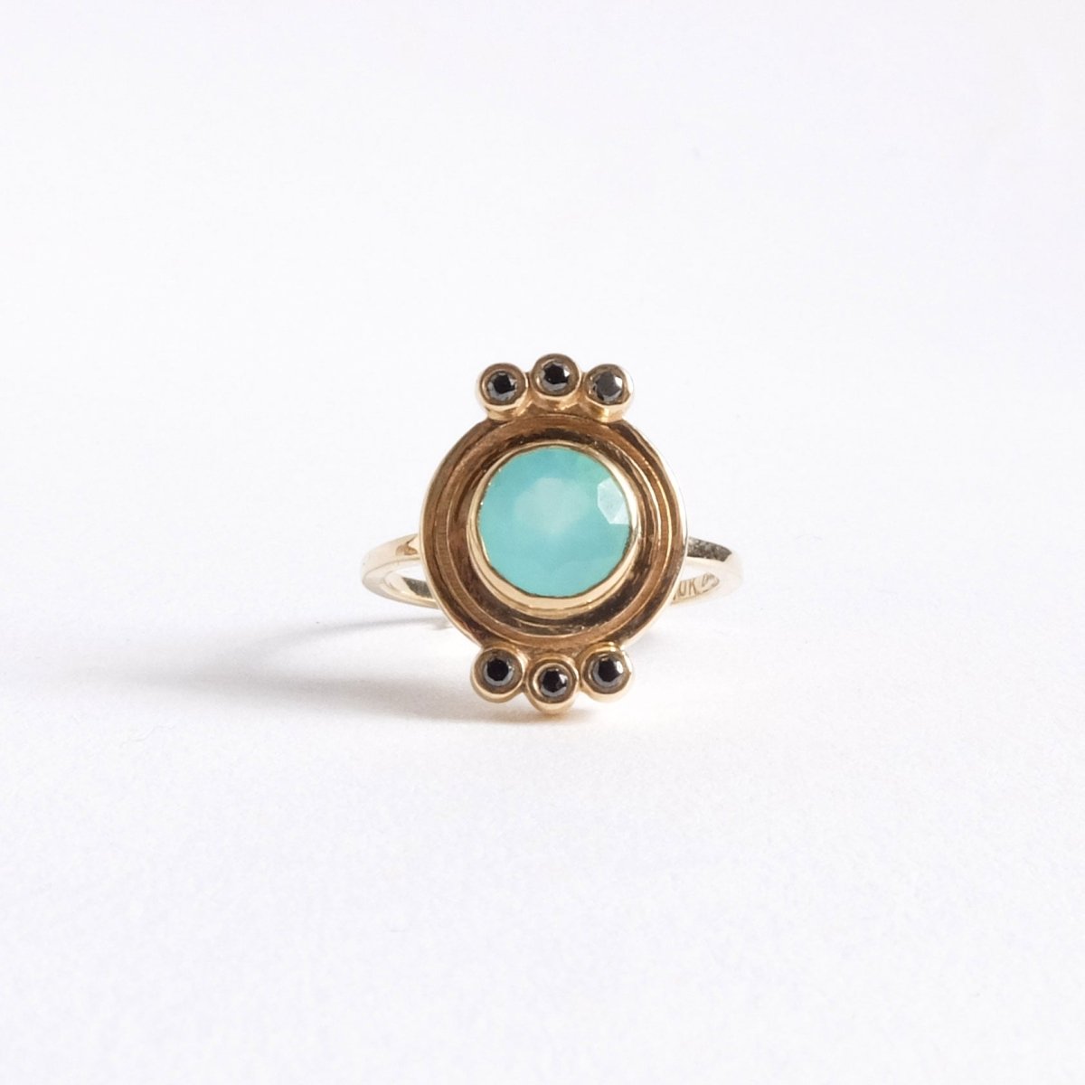 top of round Peruvian opal 10k gold ring with six black diamonds.