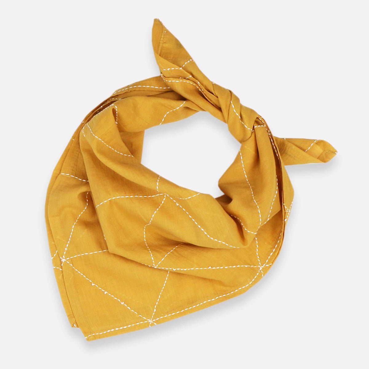 A mustard colored bandana with white stitching. The Graph Bandana in Mustard in designed by Anchal in Louisville, Kentucky and handmade in Ajmer, India.