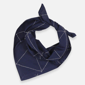A dark blue colored bandana with white stitching. The Graph Bandana in Navy is designed by Anchal in Louisville, Kentucky and handmade in Ajmer, India.