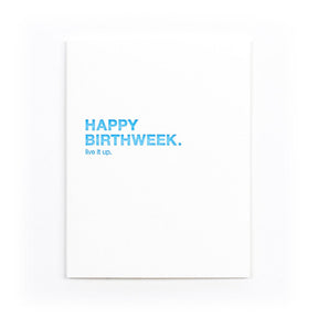 White card that reads: "HAPPY BIRTHWEEK. LIVE IT UP." Written in blue text. Designed by Sapling Press and printed in Pittsburgh, PA.