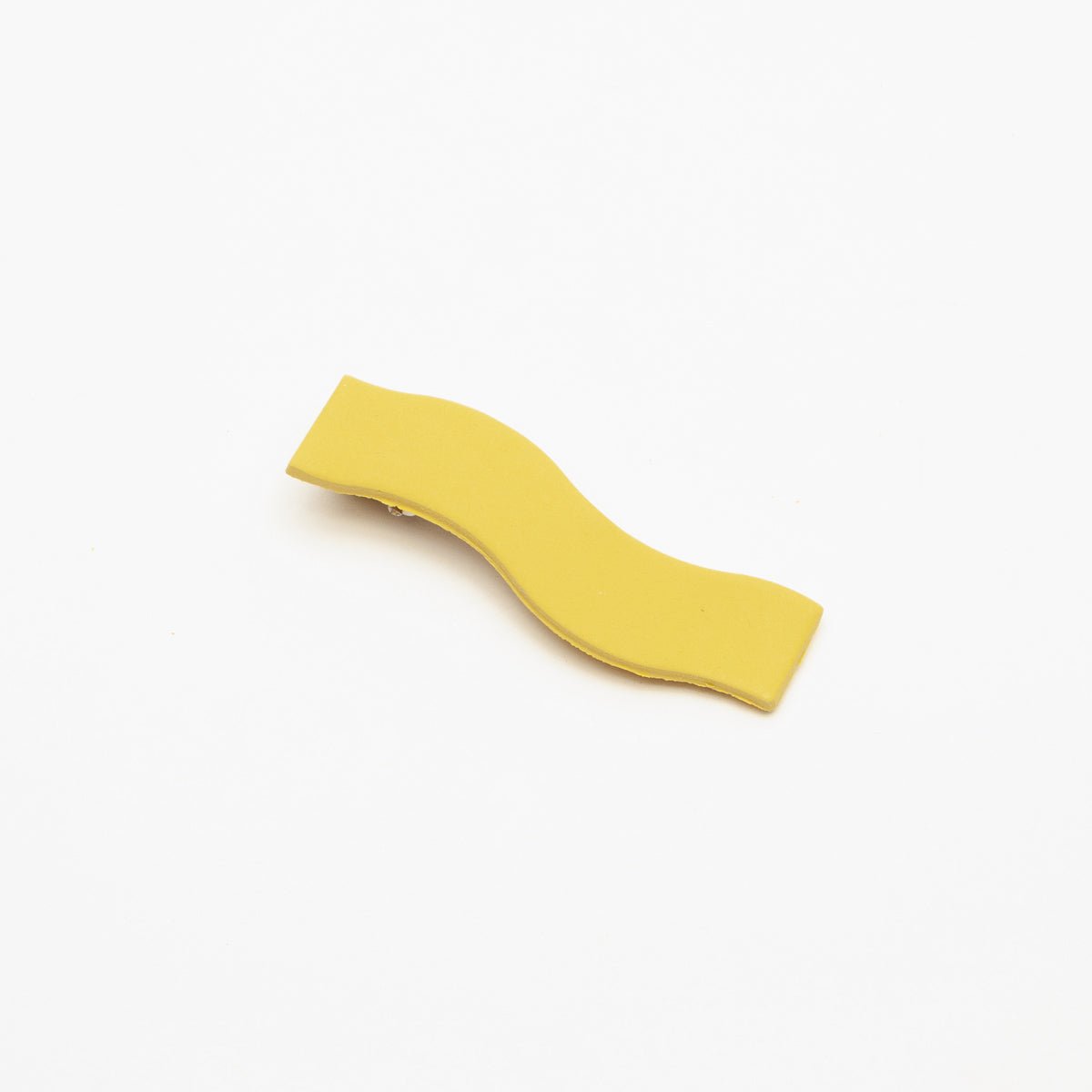Wave shaped hair clip in "Araw," a. yellow shade. Made in Los Angeles by Hey Moon Designs.