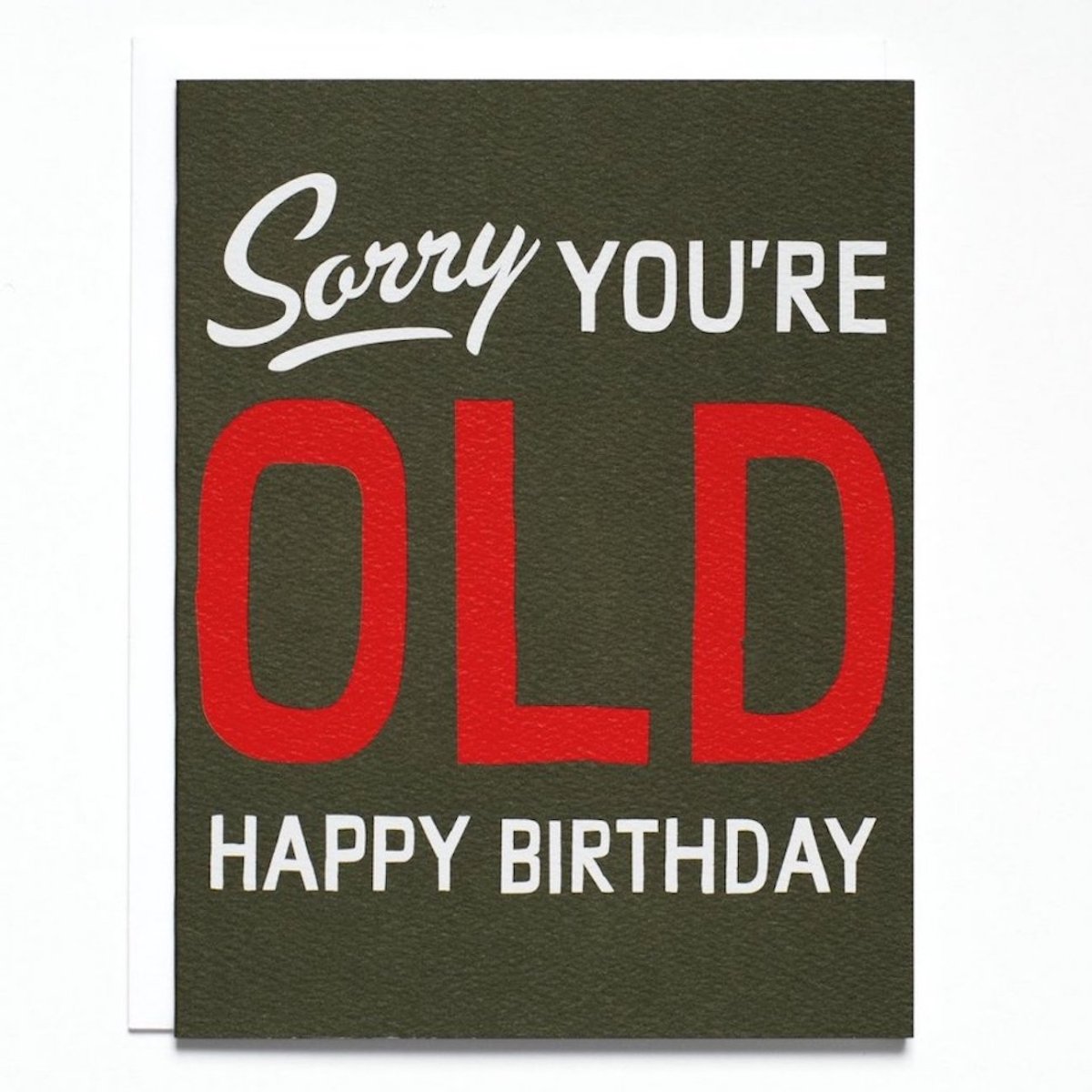 Black card with large text in white and red that reads: "SORRY YOU'RE OLD HAPPY BIRTHDAY." Made with recycled paper by Banquet Atelier in Vancouver, British Columbia, Canada.