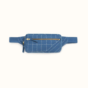 A blue crossbody bag with white stitched detail. The Crossbody Belt Bag in Cobalt is designed by Anchal in Louisville, KY and handmade in Ajmer, India
