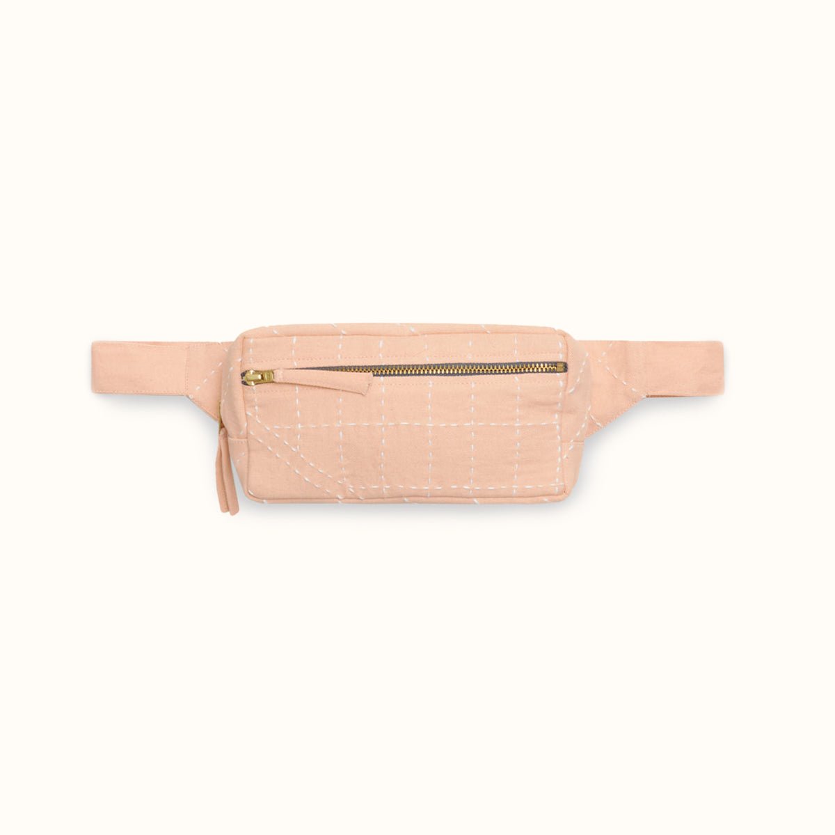 An light pink crossbody bag with white stitched detail. The Crossbody Belt Bag in Pink is designed by Anchal in Louisville, KY and handmade in Ajmer, India