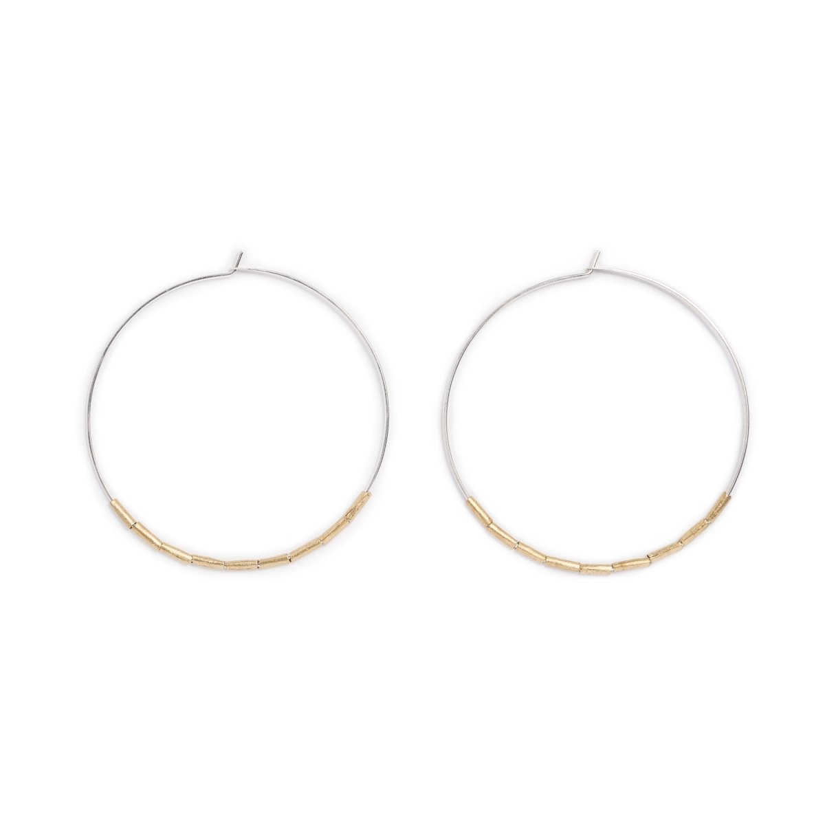 Lightweight, thin, sterling silver statement hoop earrings, accented with small, brass, African trade beads. Hand-formed in Portland, Oregon. 