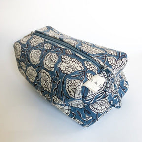 A blue and cream floral patterned cosmetic bag. The Poppy Cosmetic Bag from Maelu is designed in Portland, Oregon and printed and made in India.