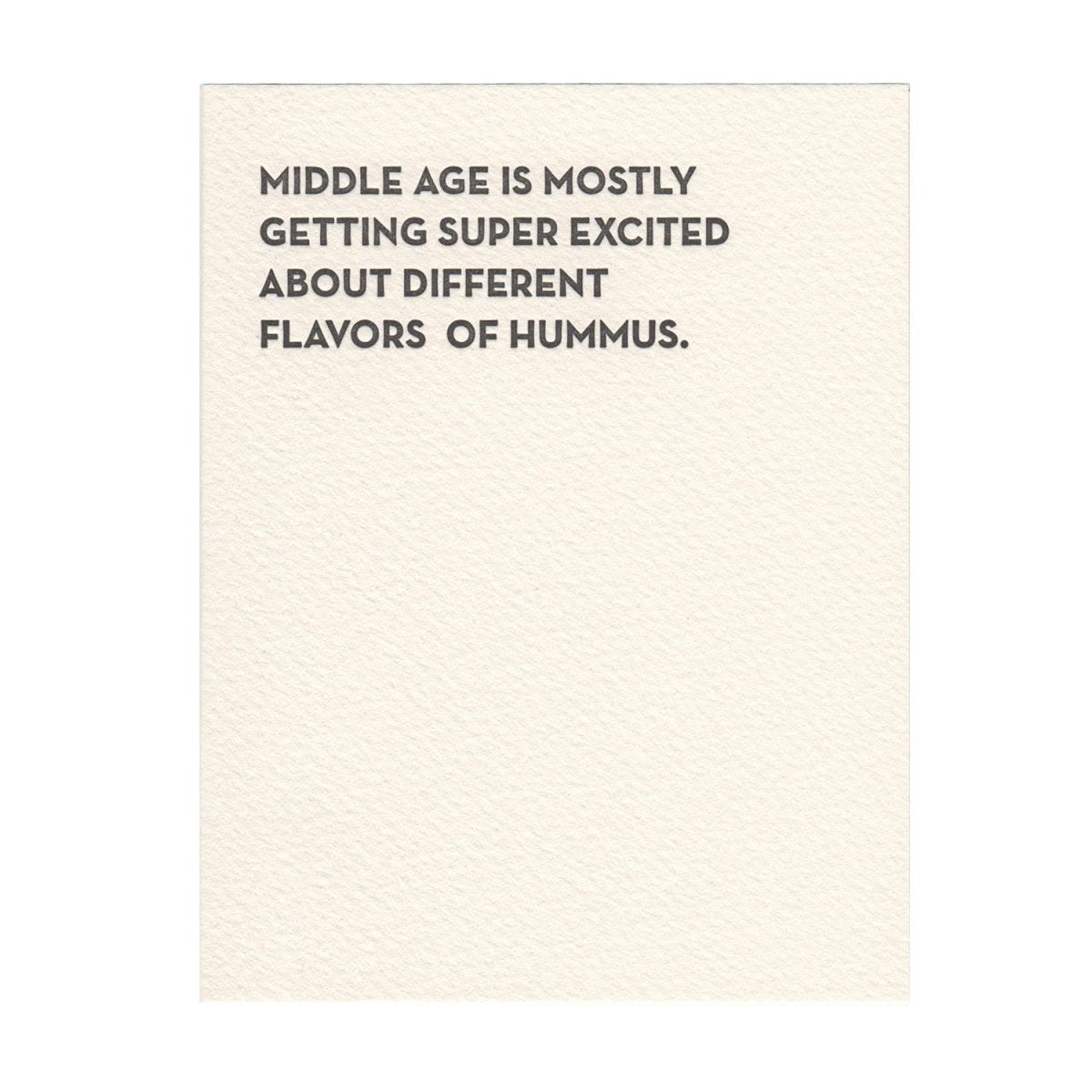 Kraft card with dark black text that reads: "MIDDLE AGE IS MOSTLY GETTING SUPER EXCITED ABOUT DIFFERENT FLAVORS OF HUMMUS." Designed by Sapling Press and printed in Pittsburgh, PA.