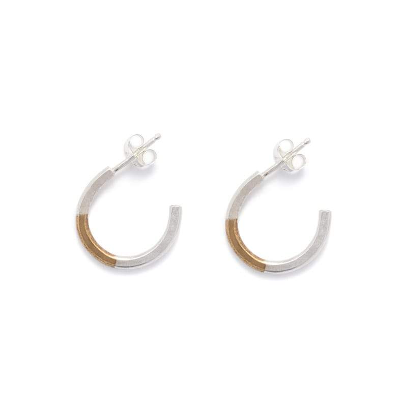 Minimalist and lightweight miniature hoop earrings of mixed brass and sterling silver hand-forged wire, with soldered sterling silver earring posts and sterling silver butterfly backings. Hand-crafted in Portland, Oregon.